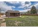 View of a large backyard featuring a wooden patio cover on a partly cloudy day at 6000 Yarrow St, Arvada, CO 80004