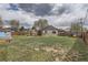 View of a large backyard featuring a wooden patio cover and a storage shed at 6000 Yarrow St, Arvada, CO 80004