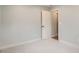 Bright bedroom features neutral carpet, trim and paint and a closet with an open door at 6000 Yarrow St, Arvada, CO 80004