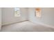 Bright bedroom features neutral carpet, trim and paint and two windows letting in natural light at 6000 Yarrow St, Arvada, CO 80004