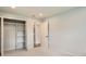 Bright bedroom features neutral carpet, trim and paint, closet and an open door to another room at 6000 Yarrow St, Arvada, CO 80004
