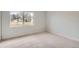 Bedroom featuring neutral carpeting, base trim and a bright view from the window at 6000 Yarrow St, Arvada, CO 80004