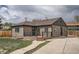 Charming single-story home featuring a welcoming front porch, landscaped yard, and private driveway at 6000 Yarrow St, Arvada, CO 80004