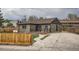 Beautifully updated home with a charming front porch, driveway, and lovely fenced yard at 6000 Yarrow St, Arvada, CO 80004