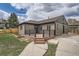 Well-maintained home featuring a charming front porch and a lovely fenced yard at 6000 Yarrow St, Arvada, CO 80004