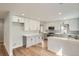 Kitchen with stainless steel appliances, white and gray cabinets, and eat-in bar at 6000 Yarrow St, Arvada, CO 80004