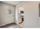 View of kitchen with stainless steel appliances and white cabinets with a door to the backyard at 6000 Yarrow St, Arvada, CO 80004