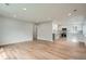 Open-concept living space featuring hardwood floors and a modern kitchen with stainless steel appliances at 6000 Yarrow St, Arvada, CO 80004