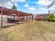 Large backyard featuring a pergola, stone feature and mature trees at 1050 Youngfield St, Golden, CO 80401