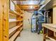 Spacious unfinished basement area with shelving, utilities, and work bench at 1050 Youngfield St, Golden, CO 80401