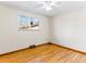 This bedroom features hardwood floors, a ceiling fan, and a large sunny window at 1050 Youngfield St, Golden, CO 80401