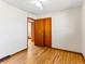 Empty bedroom with hardwood floors, a ceiling fan, and double-door closet at 1050 Youngfield St, Golden, CO 80401