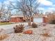 Inviting front exterior of a brick home with a well-maintained lawn and a spacious driveway at 1050 Youngfield St, Golden, CO 80401