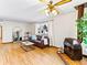 Bright living room featuring hardwood floors, a fireplace, and a large window at 1050 Youngfield St, Golden, CO 80401