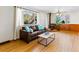 Cozy living room featuring hardwood floors, a fireplace, and a large window at 1050 Youngfield St, Golden, CO 80401