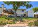 This backyard features an elevated deck, a storage shed, a beautiful tree, and grass at 11200 W 102Nd Ave, Broomfield, CO 80021