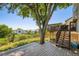 This backyard features an elevated deck, a beautiful tree, and grass at 11200 W 102Nd Ave, Broomfield, CO 80021