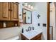 Small bathroom featuring a classic sink, a toilet, and a wood cabinet at 11200 W 102Nd Ave, Broomfield, CO 80021