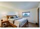 Cozy bedroom featuring a comfortable bed, a window with natural light, and neutral decor for a peaceful ambiance at 11200 W 102Nd Ave, Broomfield, CO 80021