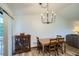 Traditional dining room showcasing a wooden table and chairs set beneath a stylish chandelier and a decorative hutch at 11200 W 102Nd Ave, Broomfield, CO 80021