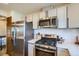 Updated kitchen features stainless steel appliances, modern cabinets, and tiled backsplash at 11200 W 102Nd Ave, Broomfield, CO 80021