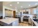 Open concept kitchen with stainless appliances, bright lighting, and a breakfast bar at 11200 W 102Nd Ave, Broomfield, CO 80021