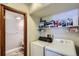 This laundry room features shelving for cleaning supplies, a washer, and a dryer at 11200 W 102Nd Ave, Broomfield, CO 80021