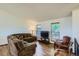 Cozy living room featuring modern wood floors, natural light, and comfortable seating at 11200 W 102Nd Ave, Broomfield, CO 80021
