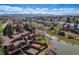 Aerial view of townhouse community on a river with mountain views at 163 Ward Ct, Lakewood, CO 80228