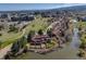 Aerial view of townhouses alongside lake with community park nearby at 163 Ward Ct, Lakewood, CO 80228