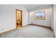Bedroom with ensuite bathroom and large window with neighborhood views at 163 Ward Ct, Lakewood, CO 80228