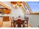 Dining area featuring a large dining table and skylight for lots of natural light at 163 Ward Ct, Lakewood, CO 80228