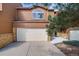 Two-story home featuring a two-car garage, brick accents, and well-maintained landscaping at 163 Ward Ct, Lakewood, CO 80228