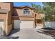 Two-story home for sale featuring a two-car garage, brick accents, and landscaping at 163 Ward Ct, Lakewood, CO 80228