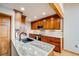 Well-lit kitchen with custom cabinets, granite counters, and stainless steel microwave at 163 Ward Ct, Lakewood, CO 80228