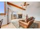 Bright living room featuring hardwood floors, wood beams, fireplace, and a sliding door at 163 Ward Ct, Lakewood, CO 80228