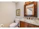 Elegant powder room with marble vanity and decorative mirror at 163 Ward Ct, Lakewood, CO 80228