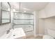 Bathroom featuring a glass door shower with blue accent tiles and a white sink and toilet at 2039 S Sherman St, Denver, CO 80210