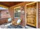 Inviting front porch with seating area, stylish rug, and natural wood front door at 2039 S Sherman St, Denver, CO 80210