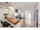 Modern kitchen with white cabinets, wood countertops, stainless steel appliances, and open layout at 2039 S Sherman St, Denver, CO 80210