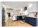 Beautiful updated kitchen with stainless appliances, navy cabinets and light countertops at 2039 S Sherman St, Denver, CO 80210