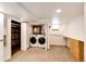 Laundry area with front loading washer and dryer, located behind louvered doors at 2039 S Sherman St, Denver, CO 80210