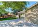 Lush green backyard with a covered patio area and an array of trees at 9852 Zephyr Dr, Broomfield, CO 80021