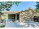 Covered patio with seating area, adjacent to a grassy backyard at 9852 Zephyr Dr, Broomfield, CO 80021