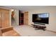 Finished basement with large TV, comfortable seating, and laundry area at 9852 Zephyr Dr, Broomfield, CO 80021