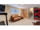 Spacious basement featuring carpet floors, a sofa, a laundry area, and stairway at 9852 Zephyr Dr, Broomfield, CO 80021
