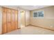 A basement with a folding door closet and a view into the bathroom at 9852 Zephyr Dr, Broomfield, CO 80021