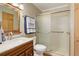Clean bathroom with vanity, toilet, and shower with sliding glass door at 9852 Zephyr Dr, Broomfield, CO 80021