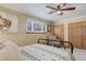 Bedroom featuring a patterned bedspread, double closets, and a comfy upholstered chair at 9852 Zephyr Dr, Broomfield, CO 80021