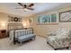 Spacious bedroom with ceiling fan, comfortable seating, and ample closet space at 9852 Zephyr Dr, Broomfield, CO 80021